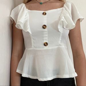 A flowy white crop top